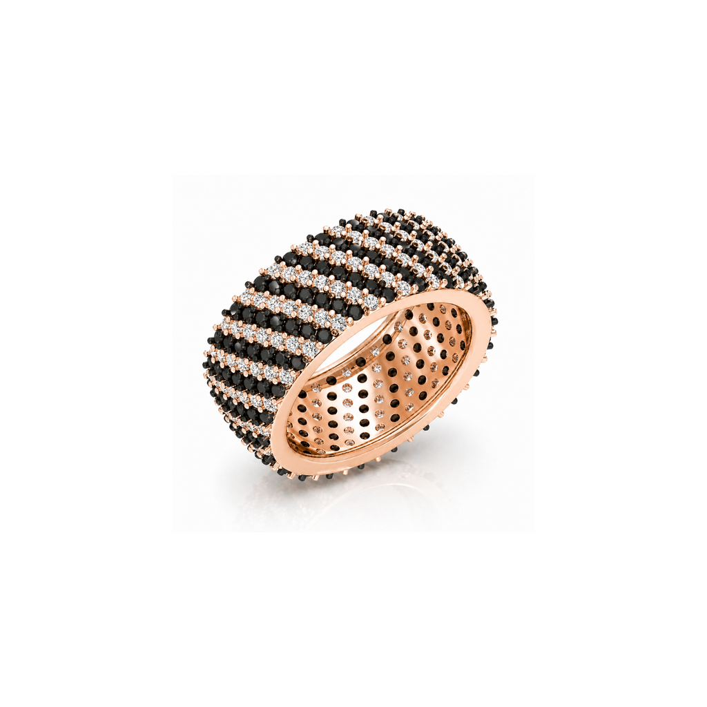 Rose gold ring with black and white gemstones on a white background