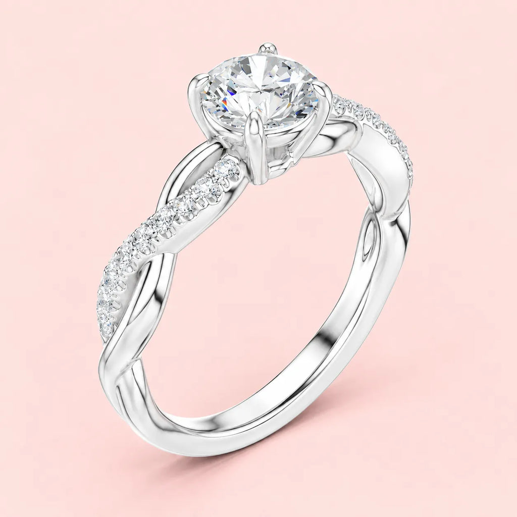 Side view of silver solitaire ring showing 4-prong round stone setting